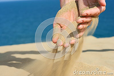 Sand in female hand Stock Photo