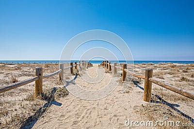 Sand footpath with wooden banisters in nature to Cabo de Gata Beach in Almeria Stock Photo