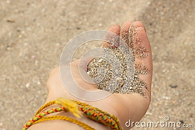 Hand is holding brown sand. Bless concept. Stock Photo