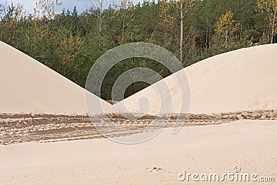 Sand heaps. Construction industry. Sand quarry. Horizontal photo. Stock Photo