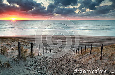 Sand path to North sea beach at sunset Stock Photo