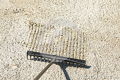 Sand rake in a golf trap, raking the sand Stock Photo