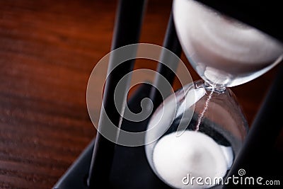 Sand running through an hour glass Stock Photo