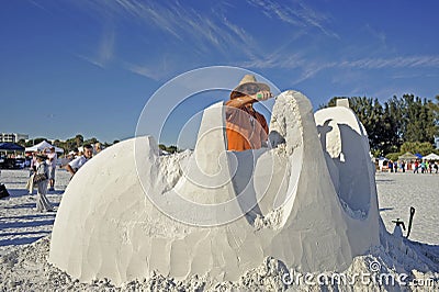 Sand sculptor uses trowel Editorial Stock Photo