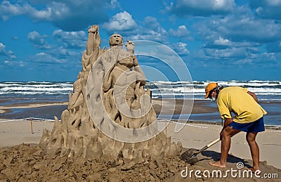 Sand sculptor at work on beach Editorial Stock Photo