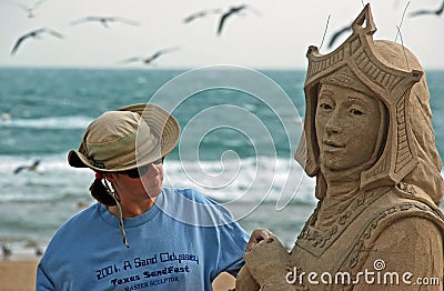 Sand sculptor working on beach Editorial Stock Photo