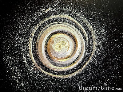 Sand spiral on the black background. The concept of rotation, golden ratio, galaxy Stock Photo