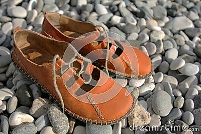 Sandals on a pebbled beach Stock Photo