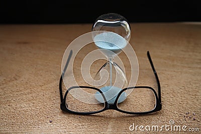 Sandglass, glasses Stock Photo