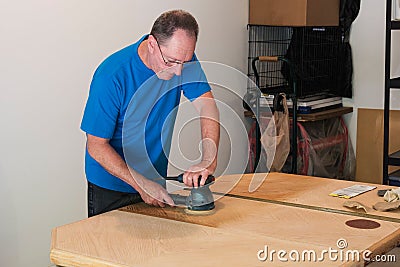 Sanding And Refinishing A Tabletop Stock Photo