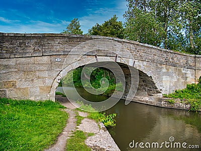 Sandstone Bridge 23 on a quiet, rural section of the Leeds to Liverpool Canal in Lancashire, UK. Stock Photo