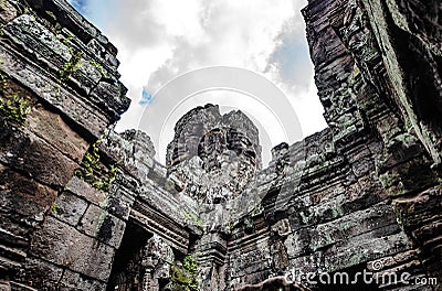 Sandstone carvings depicting a person's face on a walkway in Bayon Temple in Angkor Thom, Siem Reap Stock Photo