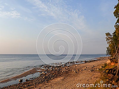 Sandstone cliffs on the seashore, beautiful reflections in the water Stock Photo