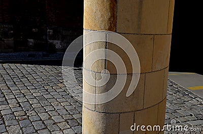 Sandstone lookout column made of sandstone blocks in the shape of a cylinder or ellipse. standing on a sidewalk of granite cubes. Stock Photo