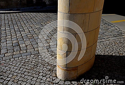 Sandstone lookout column made of sandstone blocks in the shape of a cylinder or ellipse. standing on a sidewalk of granite cubes. Stock Photo