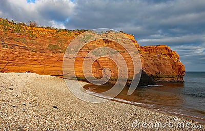 A sandstone sea stack at Ladram Bay near Sidmouth, Devon in the evening sun. Part of the south west coastal path Stock Photo