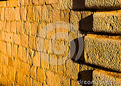 Sandstone wall illuminated by sunset. Stock Photo