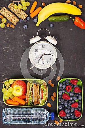 Sandwich, apple, grape, carrot, berry in plastic lunch boxes, al Stock Photo