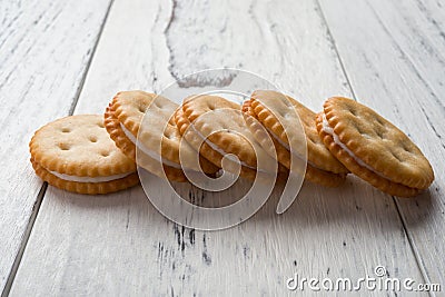 Sandwich biscuits with white cream filling on white wood Stock Photo