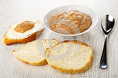 Sandwich with caviar, bread, bowl with salted pollock caviar, spoon on table Stock Photo