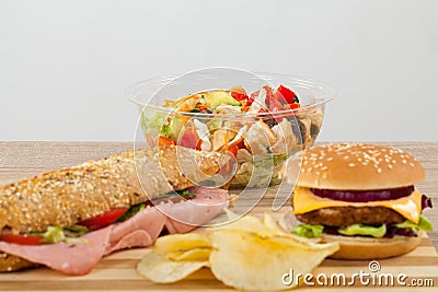 Sandwich, cheeseburger, salad and chips Stock Photo