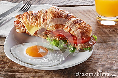 Sandwich croissant with fried bacon cheese tomato breakfast and egg Stock Photo