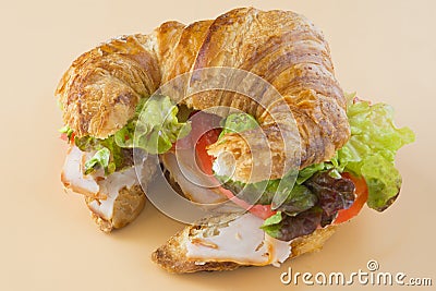 Sandwich of croissant of lettuce, tomato and smoked turkey Stock Photo