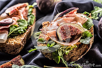 Sandwich with figs prosciutto spinach arugula and cheese dip Stock Photo