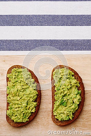 Sandwich with guacamole on light textile background top view. sandwiches on wooden board Stock Photo