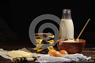 Sandwich, milk, eggs and rustic cottage cheese on a wooden background Stock Photo