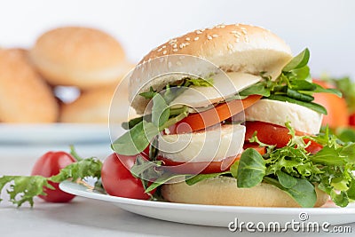 Sandwich with mozzarella, tomato and salad on the kitchen table Stock Photo