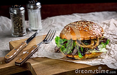 Sandwich with ostrich burger, onion, sauce and lettuce Stock Photo