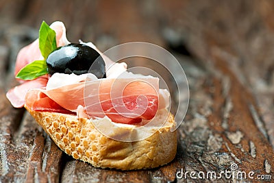 Sandwich with prosciutto olive on wooden old table horizontal Stock Photo