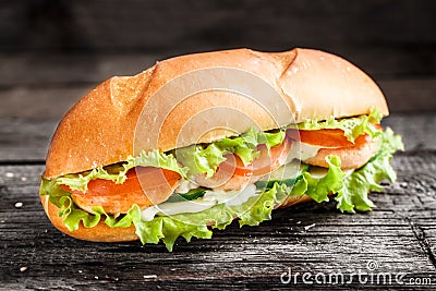 Sandwich with salmon patty and vegetables Stock Photo