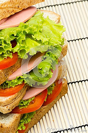 Sandwich with vegetables and bacon on bamboo Stock Photo