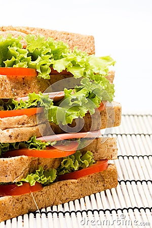 Sandwich with vegetables and bacon on bamboo Stock Photo