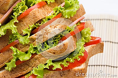 Sandwich with vegetables and bacon on bamboo close up Stock Photo