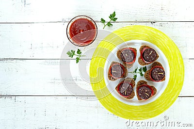 Sandwiches with black rye bread in the shape of a heart, blood sausage Morcillo and pieces of sweet pepper on skewers Stock Photo