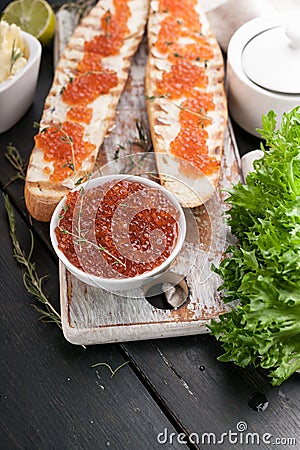 Sandwiches with butter and red salmon caviar. Gourmet breakfast. Vertical shot Stock Photo