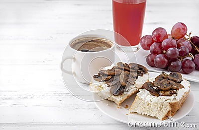 Sandwiches with cheese and mushrooms, glass of juice, 1 Cup of black coffee, grapes on a white , healthy Breakfast, copy space Stock Photo