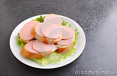 Sandwiches with doctoral sausage in a white plate Stock Photo