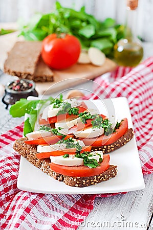 Sandwiches with mozzarella, tomatoes and rye bread Stock Photo