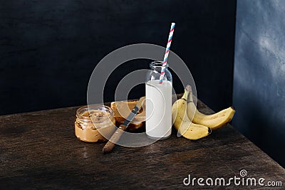 Healthy breakfast. Sandwiches peanut butter, banana, bottle of m Stock Photo