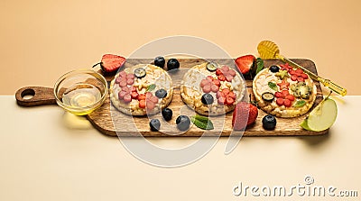 Sandwiches peanut butter with fruits, berries with honey on a wooden board, top view. Stock Photo