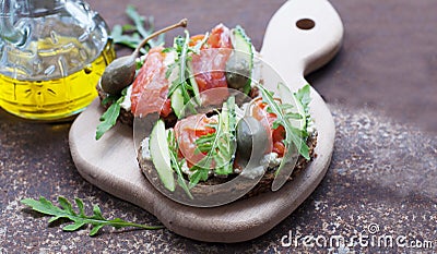 Sandwiches with trout, capers and arugula Stock Photo