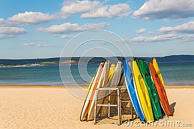 Sandy beach, color kayaks based on stand, in background beautiful view on blue ocean Stock Photo