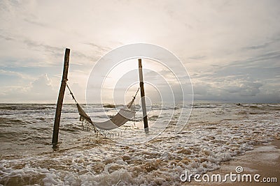 Sandy beach with hammock, sunset at beautiful adventure beach Stock Photo
