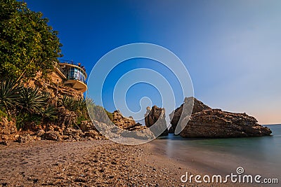 Beach in Nerja with Balcon Europa and rocks in the sea Stock Photo