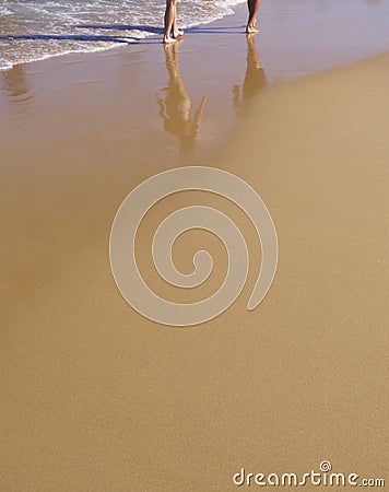 Sandy beach with walkers Stock Photo