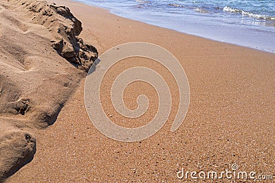 Sandy heap ashore and water inflow closeup Stock Photo